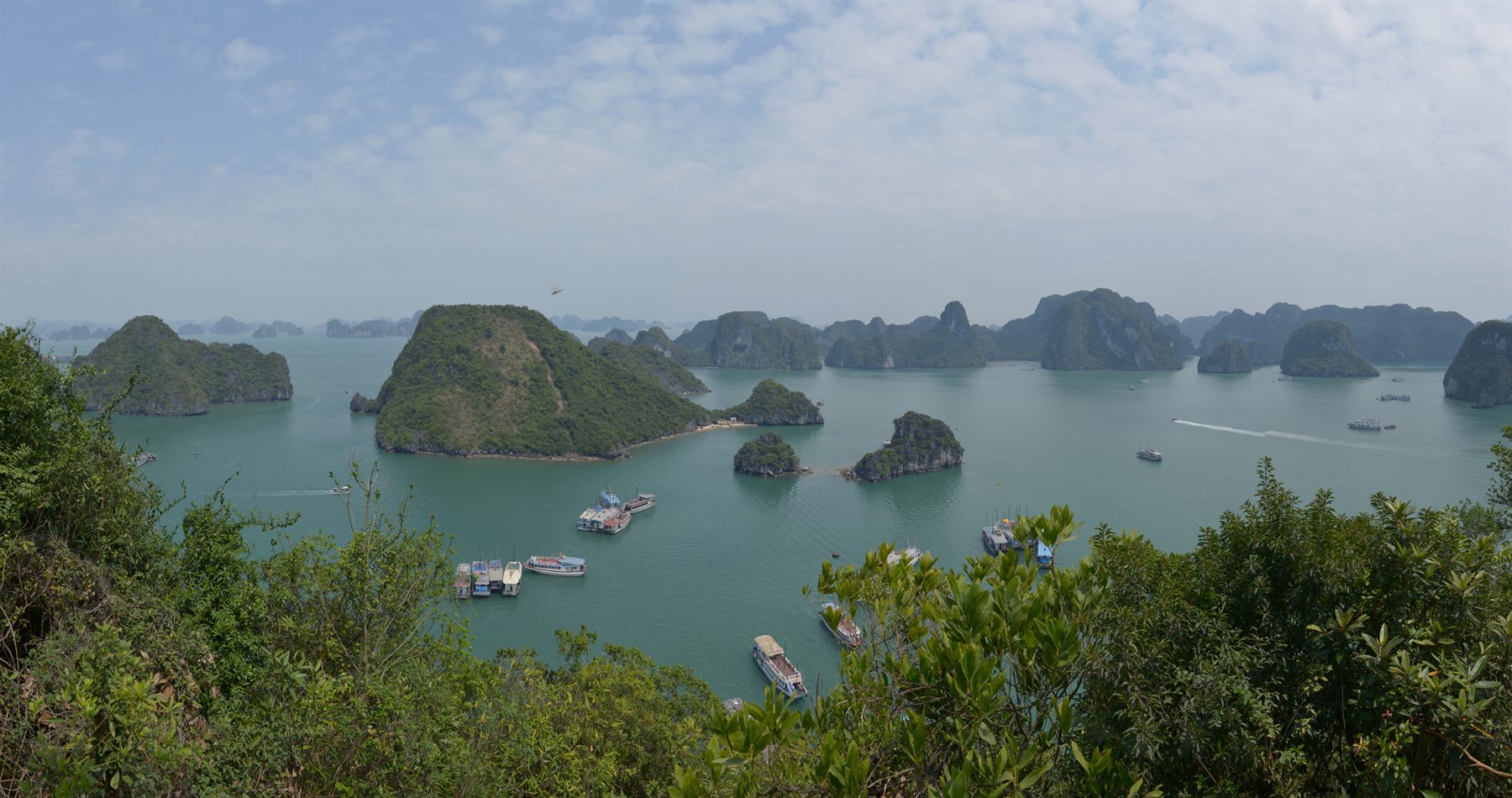Cruise boats among the limestone karsts of Halong Bay, Vietnam
